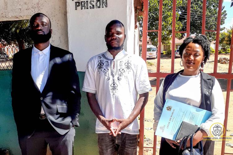 James Seyani (center) poses with Senior Legal Aid Advocate Maziko Nyirenda and Assistant Legal Aid Officer Sharon Somba