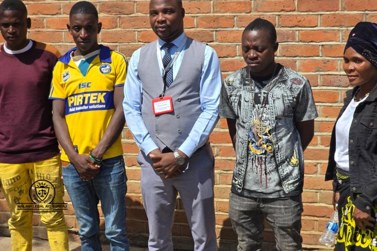 Some of the clients with ALAO Ngwira (middle).